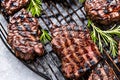 Rare steak being cooked on an iron grill, flam broiled