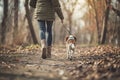 Rare view of a dog walks in the park with female owner leading the leash.