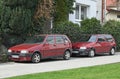 Two old classic small veteran Italian popular purple red cars Fiat Uno Fire 1.0 I.e.s parked Royalty Free Stock Photo