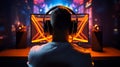 Rare view of pro gamer in headphones live streaming while playing online computer game, neon lights, esports concept
