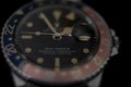 Rare vintage Rolex GMT wristwatch on black background