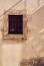 Rare vintage window of old building with lines of shadows on the wall. Copy space.