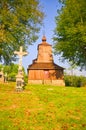 Crucifix in the front of the Wooden church of Saint Michael the Archangel in Prikra during summer sunset Royalty Free Stock Photo