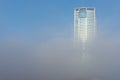 Ras Al Khaimah City in the United Arab Emirates in the early morning fog. Julphur Towers, RAK Properties, peeks above the clouds Royalty Free Stock Photo