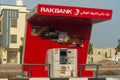 RAK Bank red logo atm sign in evening on a main road in the northern Emriates