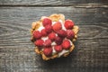 Rasberry cake decorated with fresh ripe berries on the rustic background