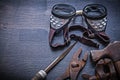 Rasp pliers clamp hammer goggles on vintage board Royalty Free Stock Photo