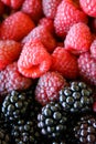 Raspberries and blackberries, vertical shot. Close up