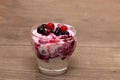 Raspberries, blueberries, blackberries mixed with natural yogurt inside a small glass Royalty Free Stock Photo