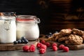 Raspberries, blueberries and homemade cookies placed on wooden platters