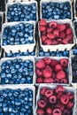 Raspberries and blueberries market display