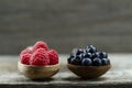 Raspberries and blueberries in spoons on wooden background. Healthy eating Royalty Free Stock Photo