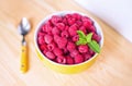 Raspberries in ceramic bowl. Ripe and tasty raspberries on a wooden background. Royalty Free Stock Photo