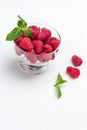 Raspberries in glass bowl. Mint leaves