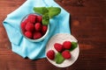 Raspberries in a glass container and on a string circle