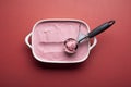Raspberries ice cream with scoop on red table. Homemade ice cream Royalty Free Stock Photo