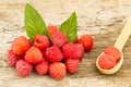 Raspberries with mint leaves closeup on wooden background, top view Royalty Free Stock Photo