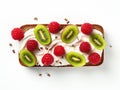 Raspberries and pieces of kiwi on a piece of bread spread with cream cheese. White background