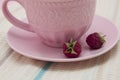 Raspberries and pink tea cup on a tea towel.Flat lay of tropical summer. Food concept Royalty Free Stock Photo