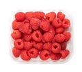 Whole fresh raspberries, ripe and red fruits, in a clear plastic punnet