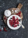 Raspberries, red and black currants, meringue on a rustic cutting board, Royalty Free Stock Photo