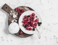 Raspberries, red and blackcurrants, a meringue on a rustic cutting board Royalty Free Stock Photo