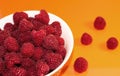 Raspberries ripe in a white bowl on a bright background Royalty Free Stock Photo