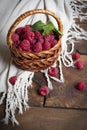 Raspberries in a small basket of vines against the background of a white napkin. Royalty Free Stock Photo