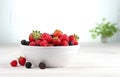 raspberries, strawberries, blackberries, wild strawberries, blueberries on white plate on white wooden table for food card design Royalty Free Stock Photo