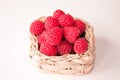 Raspberries in a white basket closeup Royalty Free Stock Photo