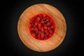 Raspberries on a wooden plate. On a black background close-up. wooden tray. view from above. place for writing. Fresh raspberries Royalty Free Stock Photo