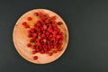 Raspberries on a wooden plate. On a black background close-up. wooden tray. view from above. place for writing. Fresh raspberries Royalty Free Stock Photo