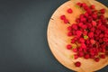 Raspberries on a wooden plate. On a black background close-up. wooden tray. view from above. place for writing. Fresh raspberries Royalty Free Stock Photo