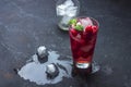 Raspberry alcoholic cocktail with liqueur, vodka, ice and mint on a dark background. Raspberry Mojito. Refreshing cool drink, Royalty Free Stock Photo