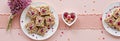 Raspberry almond bars on pink table setting with heart-shaped dishes Royalty Free Stock Photo