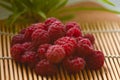 Raspberry berries close-up. A bunch of berries lying on a bamboo substrate. Royalty Free Stock Photo