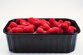 Raspberry in black container isolated on white background Royalty Free Stock Photo