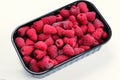 Raspberry in black container isolated on white background Royalty Free Stock Photo