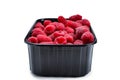 Raspberry in black container isolated on white background Royalty Free Stock Photo
