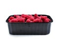 Raspberry in black container isolated on white background Royalty Free Stock Photo