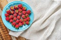 Raspberry in blue dish and in front of white fabric on old vi Royalty Free Stock Photo