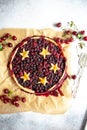 Berry pie with dough stars on a baking paper