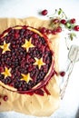 Berry pie with dough stars on a baking paper