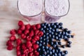 rapsberry and blueberry smoothie with fresh berries on wood table Royalty Free Stock Photo