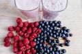 rapsberry and blueberry smoothie with fresh berries on wood table Royalty Free Stock Photo