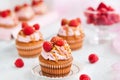 Raspberry and caramel cupcakes on white background