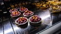 Raspberry Chocolate Tart With Frosting In Food Display Case In A Restaurant Downtown Vienna, Austria