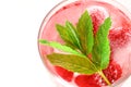 Raspberry cocktail.raspberry pink drink.Ice cubes with raspberries in a glass with water, berries and raspberry leaves