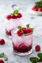 Raspberry cold drink cocktail with mint leaf and ice cubes. Summer fresh beverage in glass Royalty Free Stock Photo