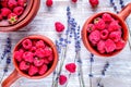 raspberry composition in pots with dry lavender on rustic background top view